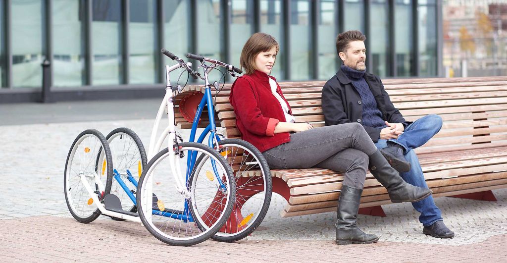 couple on a bench with city sidewalker kick bikes USA fitness